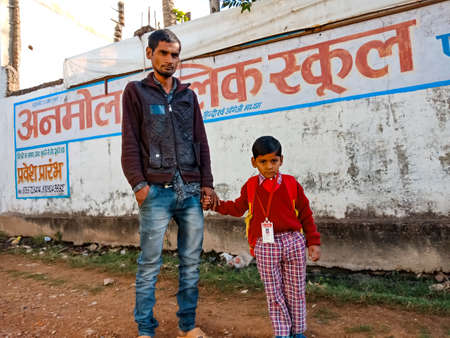 District Katni, Madhya Pradesh, India - January 07, 2020: An indian primary school boy holding hand...