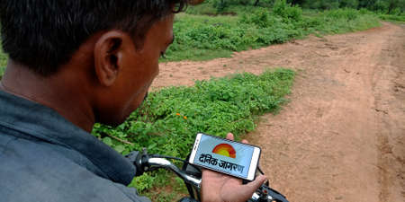 DISTRICT KATNI, INDIA - SEPTEMBER 18, 2019: Dainik Jagran online news agency logo displayed on smart phone screen by indian village man hand holding mobile concept.のeditorial素材