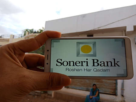 DISTRICT KATNI, INDIA - JUNE 02, 2020: An indian woman holding smart phone with displaying Soneri...