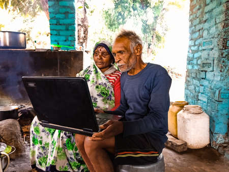 DISTRICT KATNI, INDIA - JANUARY 01, 2020: A indian matured couple learning about laptop technology together at home.のeditorial素材