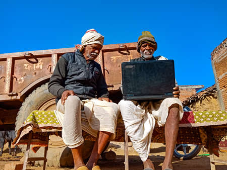 DISTRICT KATNI, INDIA - JANUARY 25, 2020: Two indian elderly man learning together about laptop...