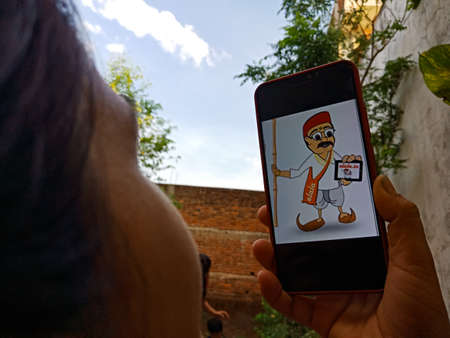 DISTRICT KATNI, INDIA - APRIL 27, 2020: An indian girl displayed E-lala cartoon logo on smart phone...