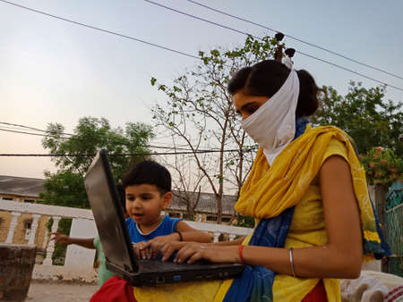 DISTRICT KATNI, INDIA - MAY 23, 2020: An indian female giving training about laptop technology to...