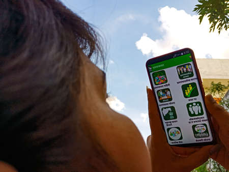 DISTRICT KATNI, INDIA - APRIL 27, 2020: An indian girl displayed Gram panchayat app on smart phone...
