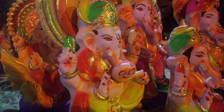 DISTRICT KATNI, INDIA - AUGUST 7, 2019: Sculptures, offerings and a hand-carved statue of the Hindu Elephant God Ganesha at a carver's shop in the local street.のeditorial素材