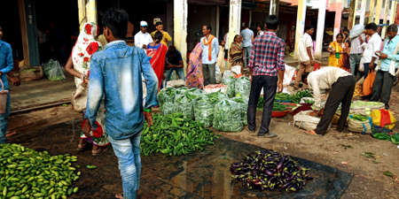 DISTRICT KATNI, INDIA - AUGUST 07, 2019: Asian boy walking on crowd at Fresh green vegetable street...