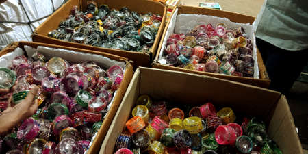 DISTRICT KATNI, INDIA - AUGUST 02, 2019: Background of colorful bangles stacked in a shop in India with glitter and plain colored bangles. The bangles are worn special occasions by Indian women.のeditorial素材