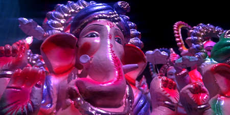DISTRICT KATNI, INDIA - AUGUST 7, 2019: Soil Sculptures, offerings and a hand-carved statue of the Hindu Elephant God Ganesha at a carver's shop in the local street.のeditorial素材