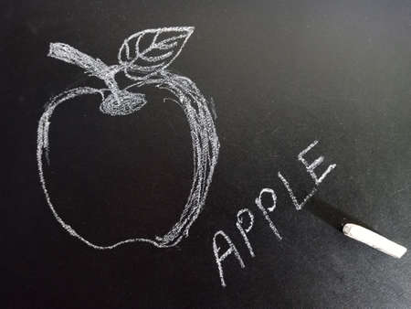 Apple word with image displayed on black board for learning and awareness terminology for education...