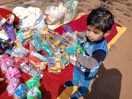 DISTRICT KATNI, INDIA - FEBRUARY 02, 2020: Indian children buying toys during festival season at local bazaar Fest.のeditorial素材