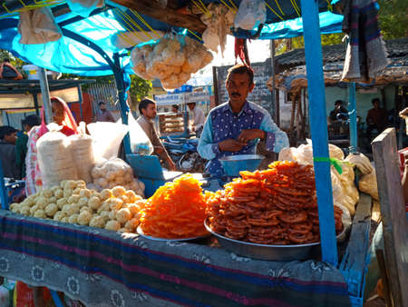 DISTRICT KATNI, INDIA - FEBRUARY 02, 2020: Indian village woman selling traditional sweet called...