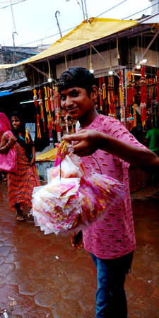 DISTRICT KATNI, INDIA - AUGUST 12, 2019: An indian village street boy selling beautiful rakhi during...