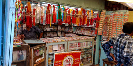DISTRICT KATNI, INDIA - AUGUST 12, 2019: An indian shopkeeper selling beautiful rakhi during hindu...