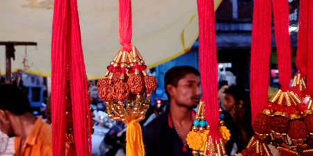 DISTRICT KATNI, INDIA - AUGUST 14, 2019: Hand made Rakhi hanging for sale at indian traditional village market, during hindu religious festival called Raksha Bandhan.のeditorial素材