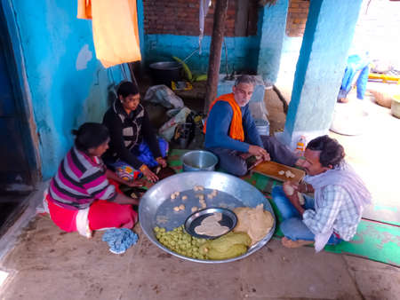 DISTRICT KATNI, INDIA - OCTOBER 06, 2019: Group of people cooking indian traditional food for festival party.のeditorial素材