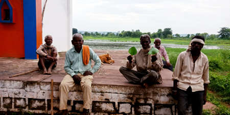 DISTRICT KATNI, INDIA - AUGUST 03, 2019: Group of village poor people seating together enjoying oldage with friends at open environment.のeditorial素材
