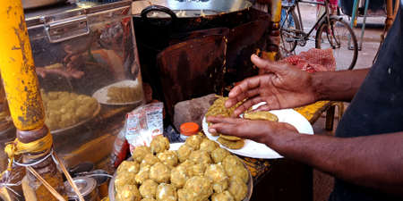 DISTRICT KATNI, INDIA - SEPTEMBER 19, 2019: An indian street food seller making samosa by hand.のeditorial素材