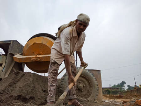 DISTRICT KATNI, INDIA - DECEMBER 18, 2019: An indian village male labor holding spade on hand for...