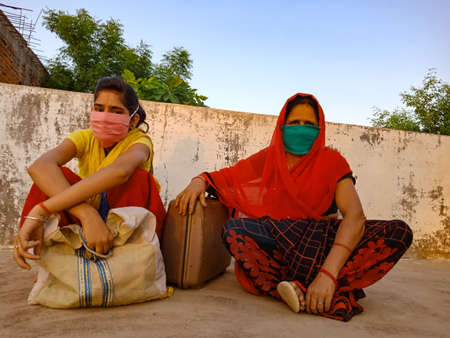 DISTRICT KATNI, INDIA - MAY 21, 2020: Indian village mother and daughter wearing face mask for...