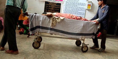 DISTRICT KATNI, INDIA - SEPTEMBER 18, 2019: Indian village patient lying on stretcher at city government hospital.のeditorial素材