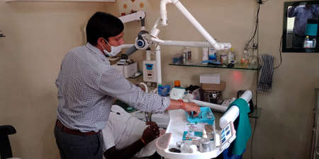 DISTRICT KATNI, INDIA - SEPTEMBER 29, 2019: An indian male dentist working at dental clinic in city hospital.のeditorial素材