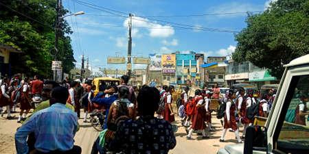 DISTRICT KATNI, INDIA - AUGUST 08, 2019: Indian people waiting for school students traffic clearance on road.のeditorial素材