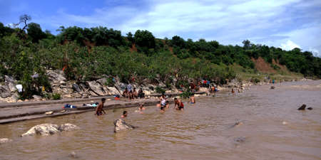CITY JABALPUR, INDIA - AUGUST 18, 2019: Indian people bathing at Narmada River in Bhedaghat around Dhuandhar waterfall.のeditorial素材