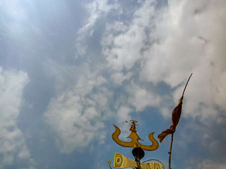 DISTRICT KATNI, INDIA - OCTOBER 10, 2019: Lord shiva trident isolated on sky background.