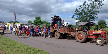 DISTRICT KATNI, INDIA - SEPTEMBER 12, 2019: Indian village people going with tractor in Hindu religious traditional road show at Lord Ganesha immersion ceremony.のeditorial素材