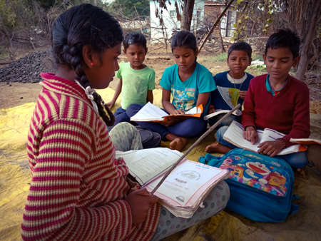DISTRICT KATNI, INDIA - JANUARY 01, 2020: An Indian government school poor girl teaching group of...
