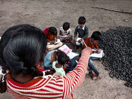 DISTRICT KATNI, INDIA - JANUARY 01, 2020: Asian poor farmers kids learning together during village...