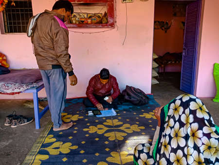 DISTRICT KATNI, INDIA - JANUARY 16, 2020: Indian village man paying installment for Micro finance...