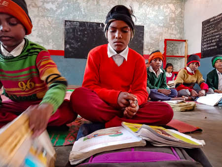 DISTRICT KATNI, INDIA - JANUARY 21, 2020: Indian government school village students reading syllabus...