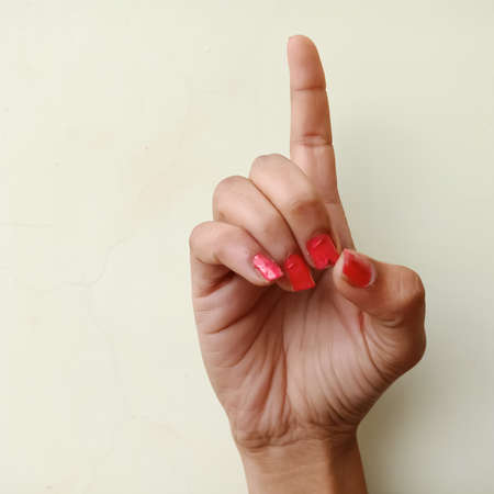 Sign language, A collage of the American sign language alphabet D by female hand isolated on white background.の写真素材
