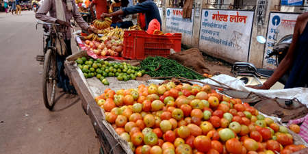 DISTRICT KATNI, INDIA - SEPTEMBER 24, 2019: Fresh tomato presented for sale at indian street bazaar season sale by village greengrocer.のeditorial素材