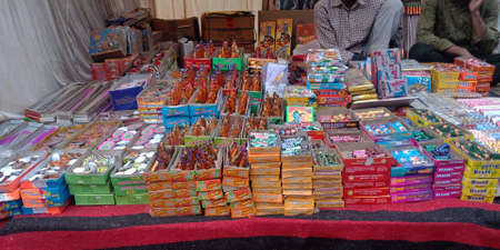 DISTRICT KATNI, INDIA - OCTOBER 15, 2019: Colorful Crackers displayed by asian salesman during hindu tradition Diwali festival at indian street city bazaar.のeditorial素材