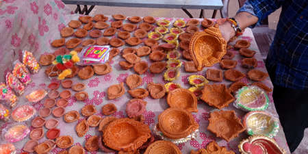 DISTRICT KATNI, INDIA - OCTOBER 19, 2019: Soil made lamp presented for sale on street bazaar shop during hindu diwali festival.のeditorial素材