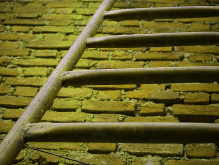 Iron stair down to up picture on brick wall background, Motivation to success conceptの写真素材