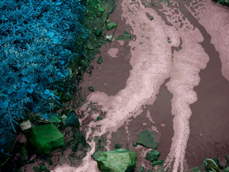 White water foam on gutter flow presented around dirty environment