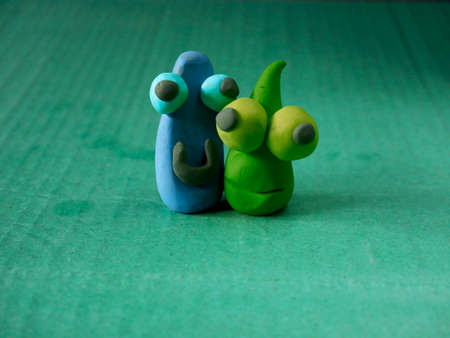 Loving clay cartoon creature standing together with loving posture