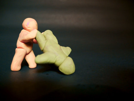 Two man fighting together clay cartoon soft toy on silver background