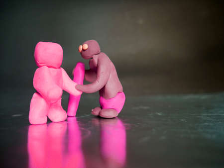 Clay cartoon old man shaking hand with pink robot technology conceptの写真素材