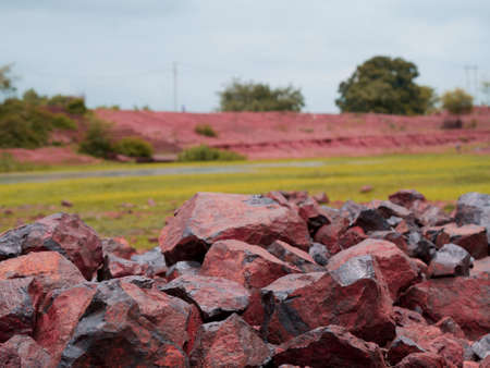 Mountain stone stock kept at grass nature field on sky backdrop.の写真素材