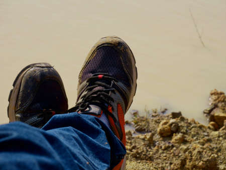Dirty shoes due to rain season traveling, lifestyle concept.