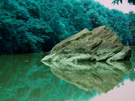 Extreme big stone rock water reflection image presented at river nature shot.の写真素材