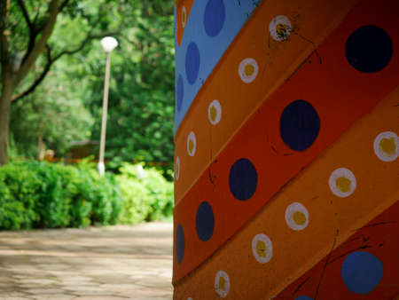 Colorful dotted side frame image at blur garden background.