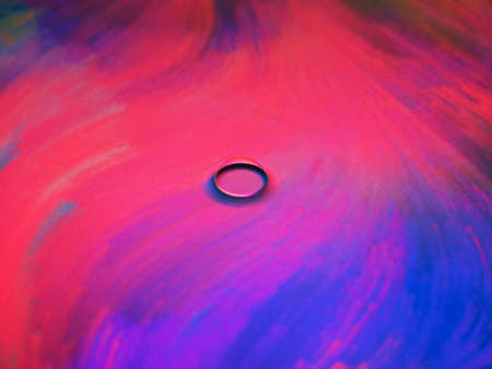 Amazing water bubble isolate on colorful screen surface.の写真素材