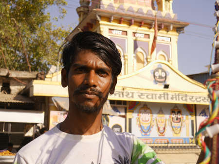 DISTRICT KATNI, INDIA - MARCH 02, 2022: An asian man looking at front at hindu temple blur background.のeditorial素材
