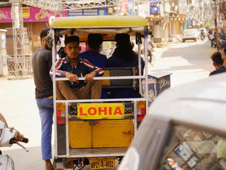 Public transport auto rickshaw standing on road waiting for people, image captured from back at city Katni Madhya Pradesh in India on March 2022.のeditorial素材