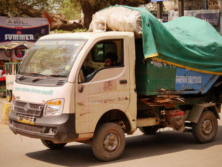 Indian municipal corporation garbage collection vehicle standing on road at day time at city Katni Madhya Pradesh in India on March 2022.のeditorial素材
